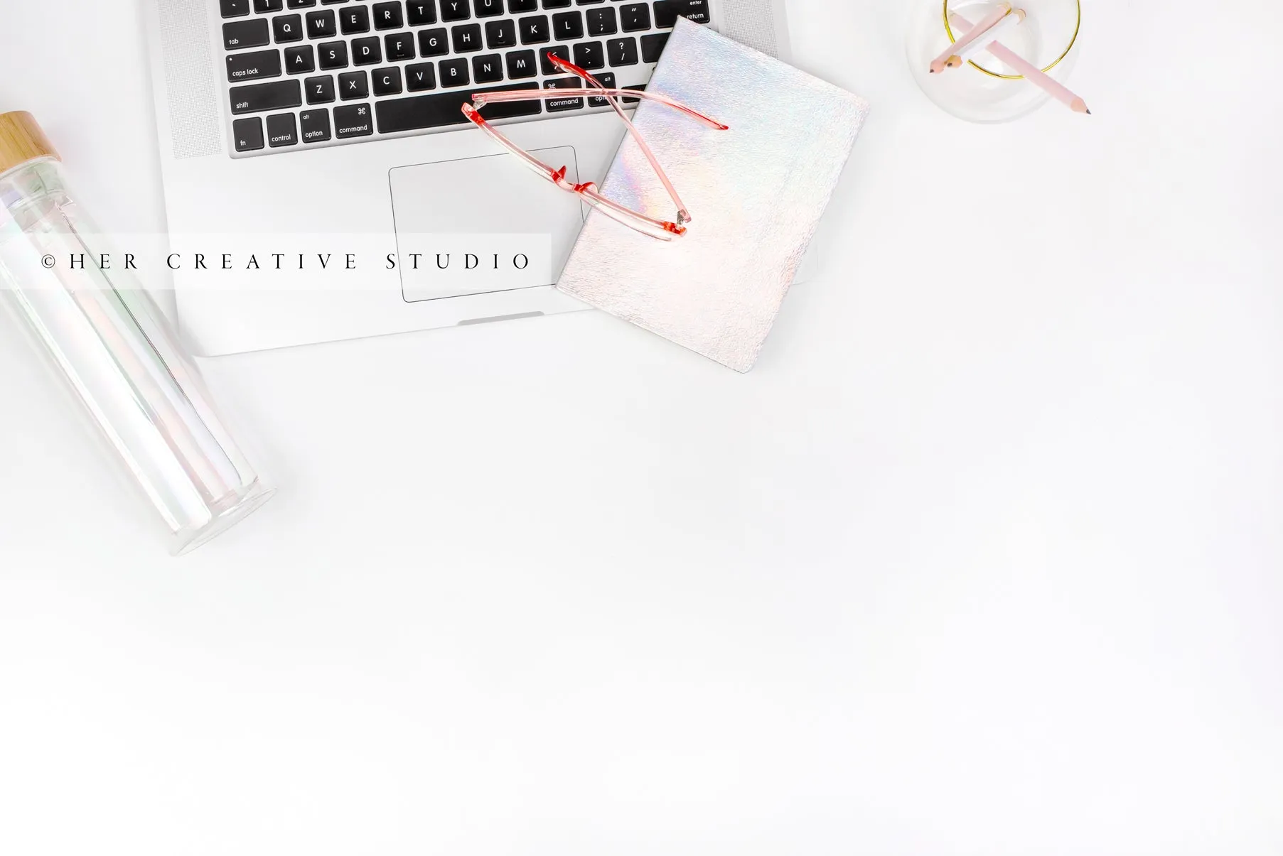 Glasses on Iridescent notebook Flatlay