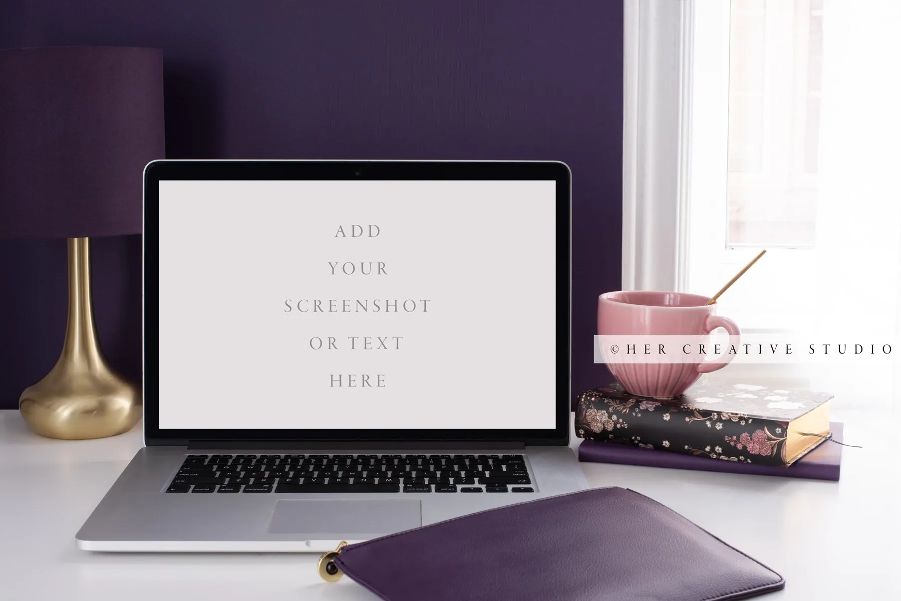 Laptop with Notebook on Purple Workspace. Stock Photo.