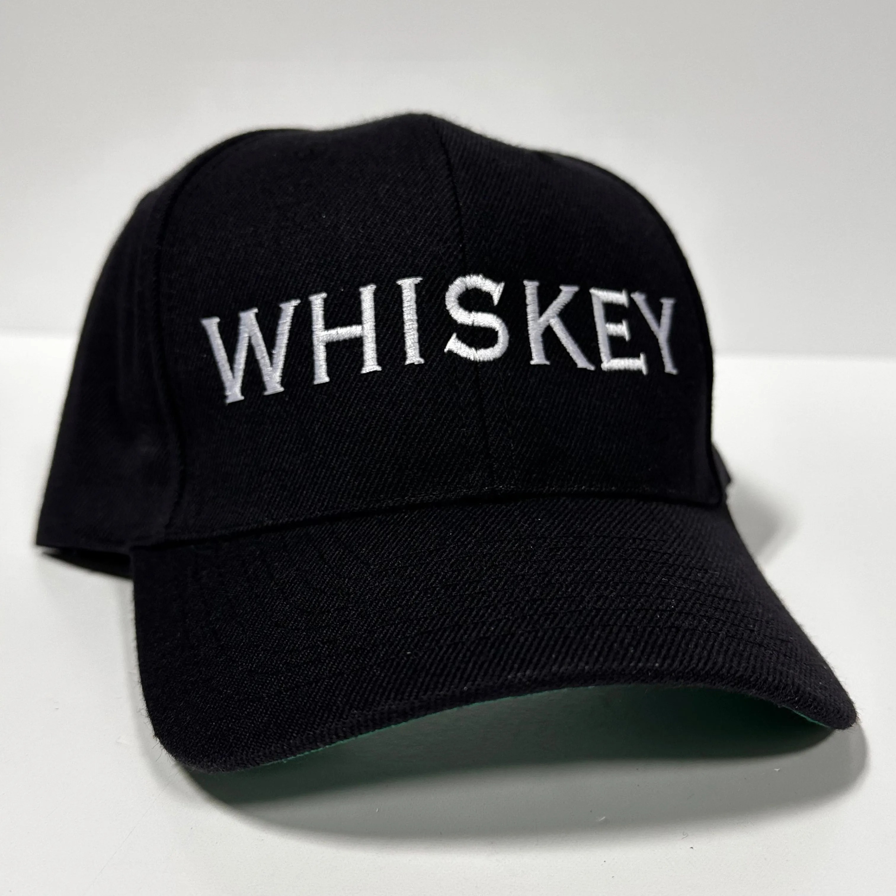 Whiskey embroidered on a black SnapBack Hat Cap Custom Embroidery